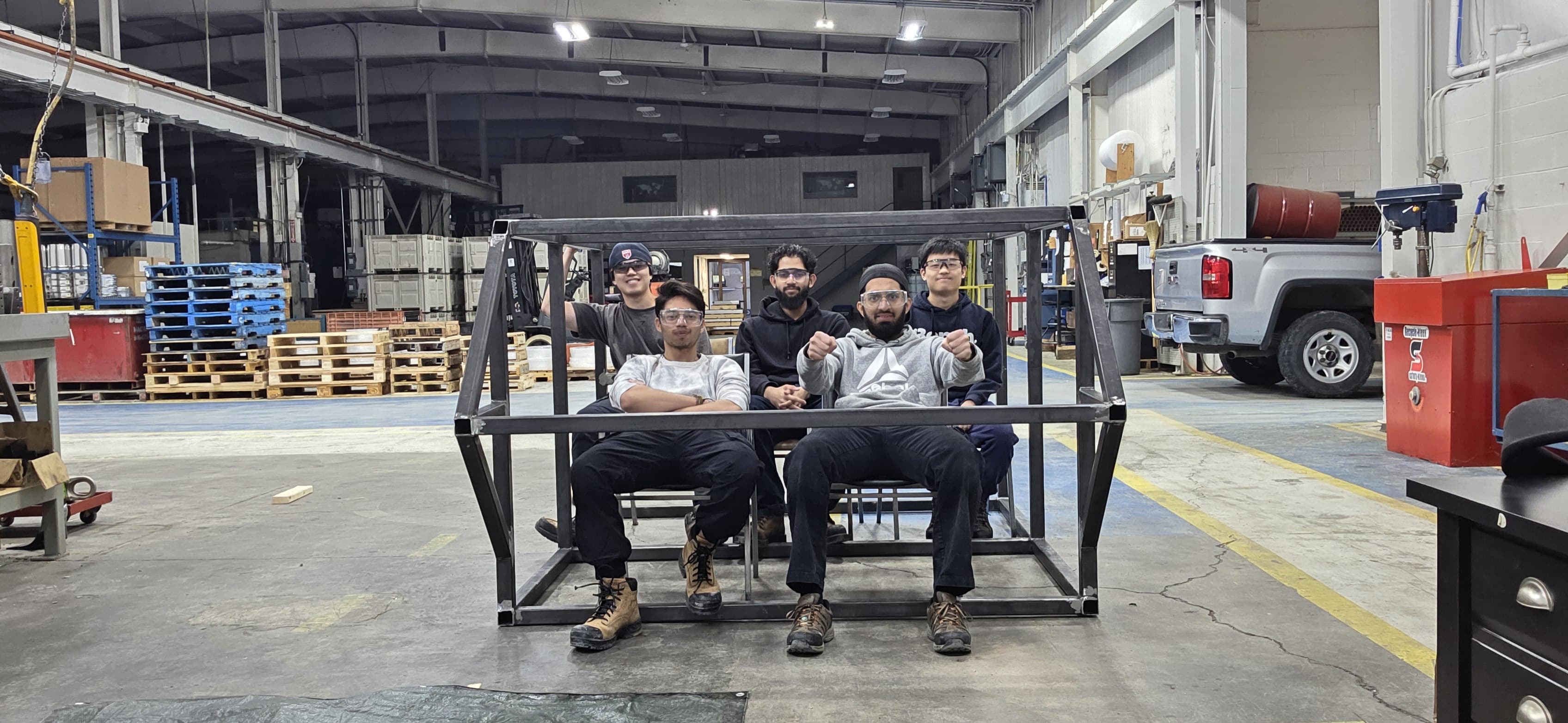 Kentus team inside the partial steel cab mock-up on the shop floor
